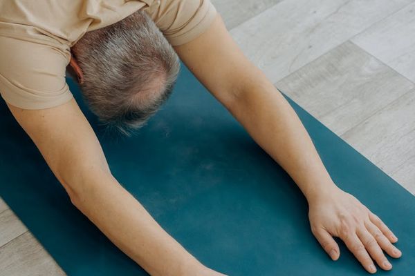 Detailed view of yoga stretching exercises on a mat.